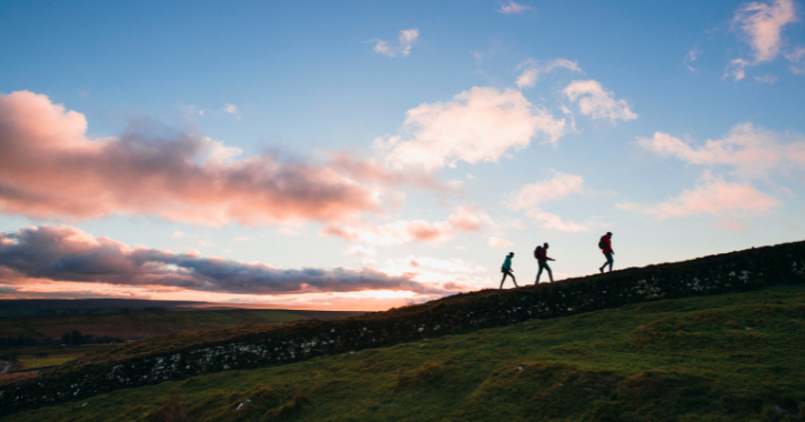 Group of people walking along Hadrian's Wall in Northumberland